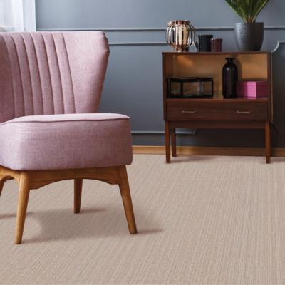 textured beige carpets in a living room with a pink accent chair